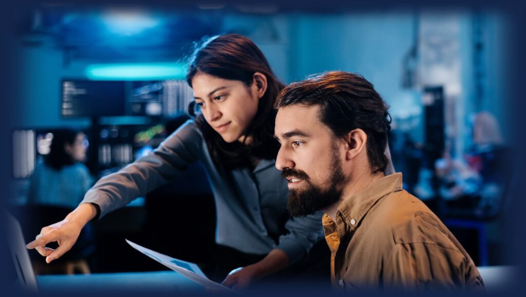 employees looking at a laptop together