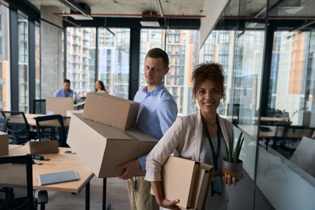 Employees moving boxes during office relocation